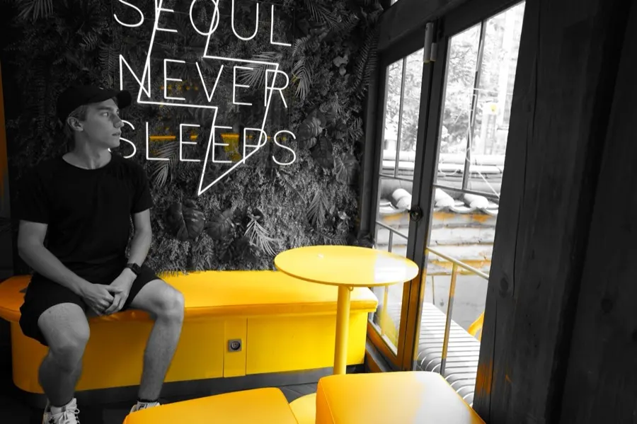 In a cafe under a Seoul Never Sleeps sign